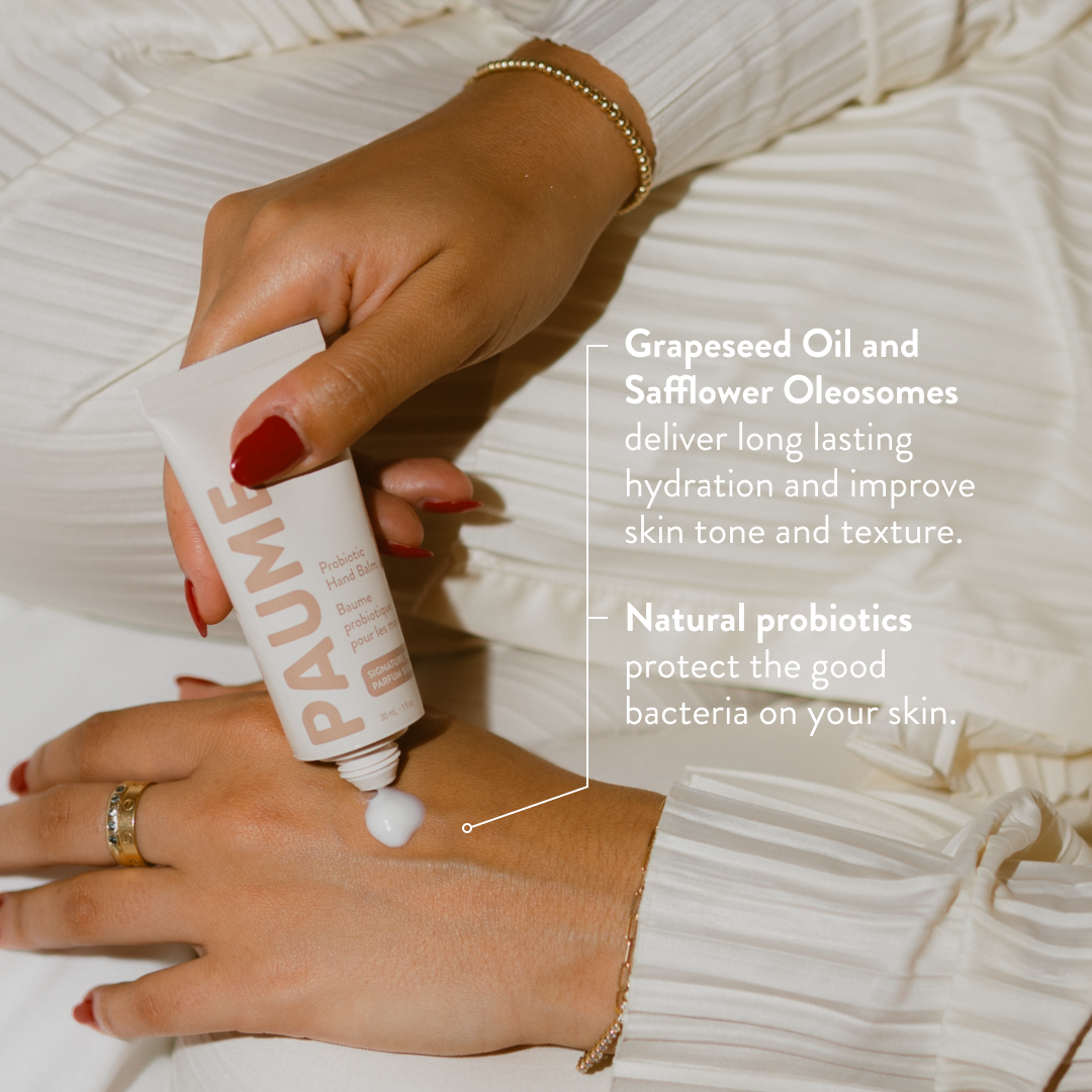 Hand applying PAUM skincare product with text about ingredients on a white background