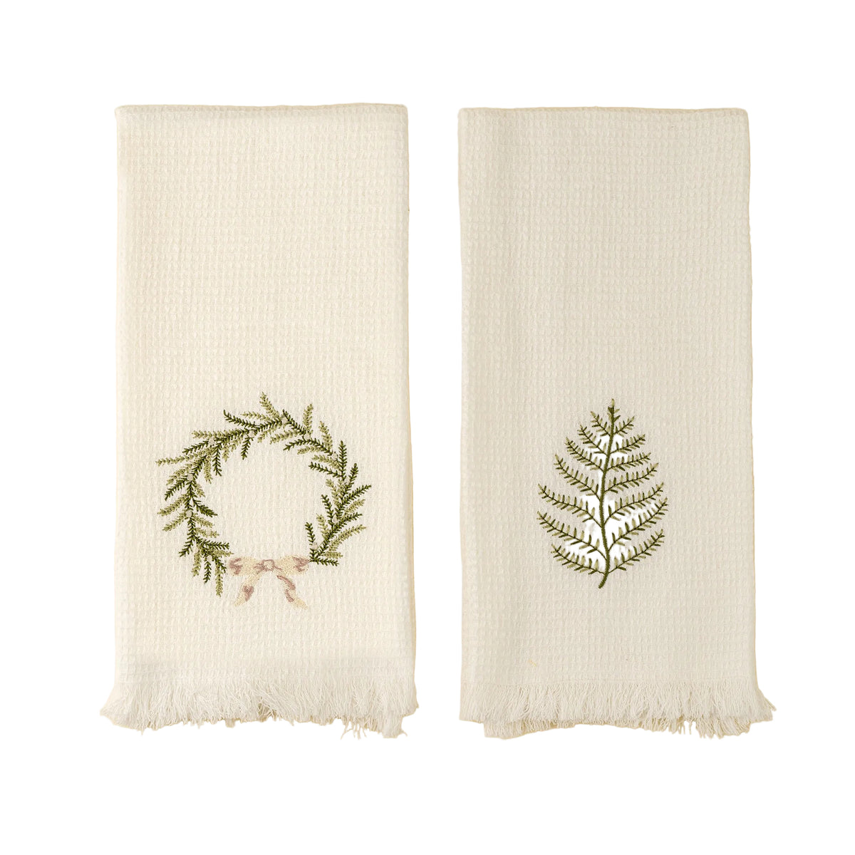 Two embroidered towels with green leaf designs on a beige background